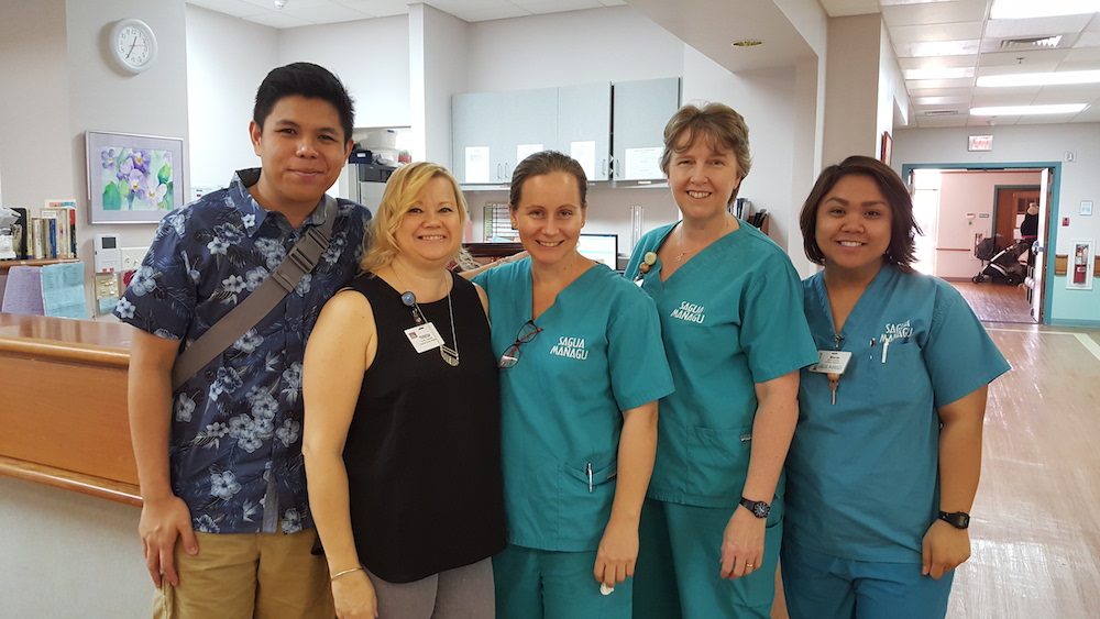 Adrian Medina pictured with FNU alum Teresa Anderson and birth center nurses.