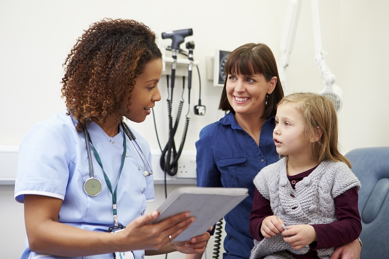 Nurse Practitioner hugging child